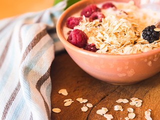 Smoothie yogurt bowl with oats and berries on wooden rustic board. Healthy eating breakfast