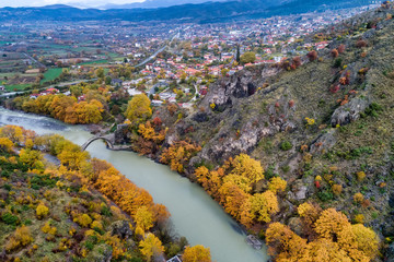 Aerial view of Konitsa old bridge and Aoos River an autumn day, Greece.