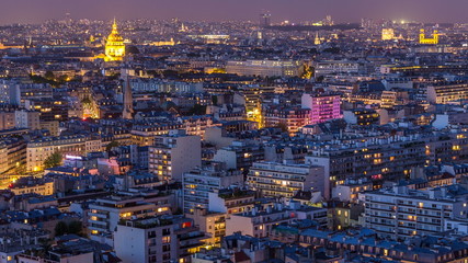 Fototapeta na wymiar Aerial panorama above houses rooftops in a Paris day to night timelapse