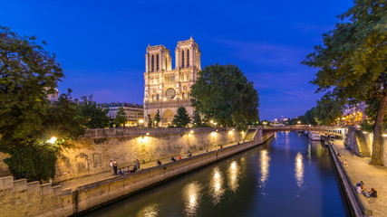 Fototapeta na wymiar Front view of Notre Dame De Paris cathedral day to night timelapse after sunset.