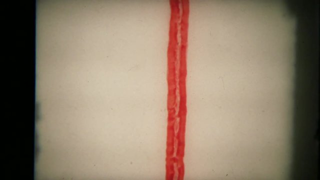 Words, letters and lines from a badly damaged super 8 mm movie being projected.