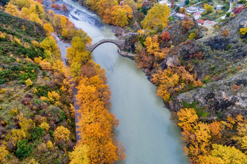 Aerial view of Konitsa old bridge and Aoos River an autumn day, Greece.