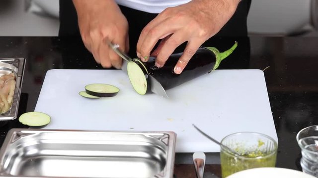 chef masterfully cutting colorful vegetables on a cutting board
