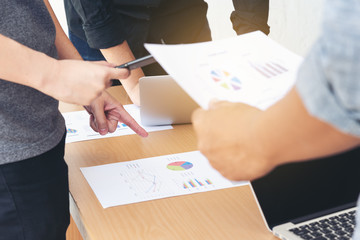 Business team Consultations and meetings. Holding a summary of sales and operations of the company in hand. At the meeting, the company's operationsb