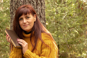 Girl reading a book in the forest, toning