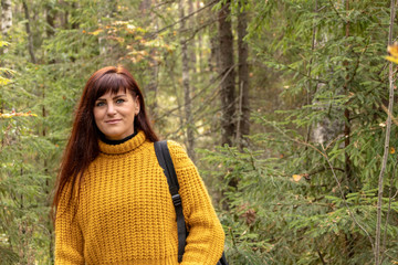Girl goes out of the woods with a backpack, toning