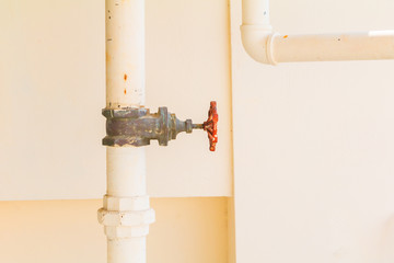 water valve drink rust pipe outside a building with copy space.