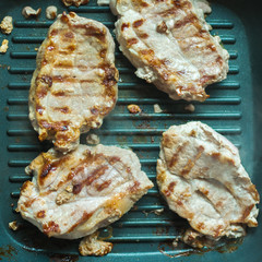 Pieces of roasted meat in a grill. Preparation of meat without oil.