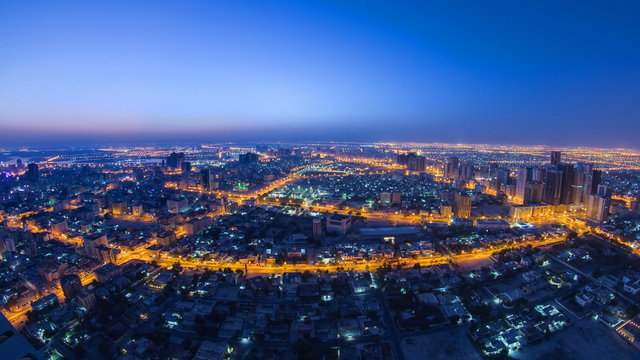 Fototapeta Cityscape of Ajman from rooftop night to day timelapse. Ajman is the capital of the emirate of Ajman in the United Arab Emirates.