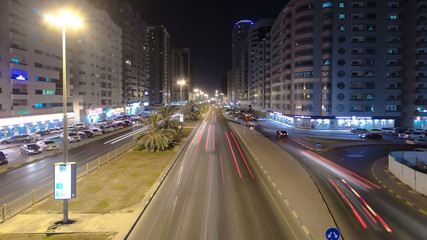 Fototapeta na wymiar Cityscape of Ajman from bridge at night timelapse. Ajman is the capital of the emirate of Ajman in the United Arab Emirates.