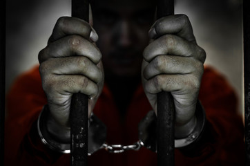 Male prisoners are in the prison by captured shackled