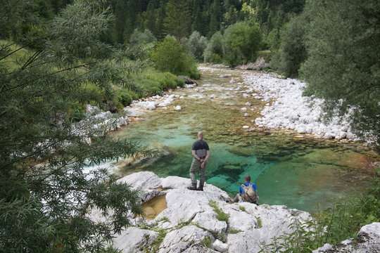 Soca, Slovenia - June 10, 2018: Fishermen fishing trouts in lepena valley, Slovenia