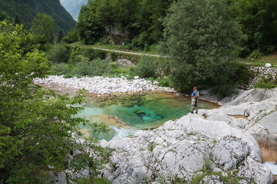 Soca, Slovenia - June 10, 2018: Fishermen fishing trouts in lepena valley
