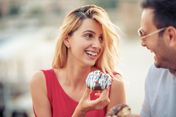 Couple eating donuts