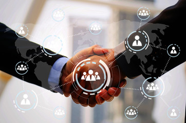 business man in suit handshake after finishing up a business meeting with virtual innovation,...
