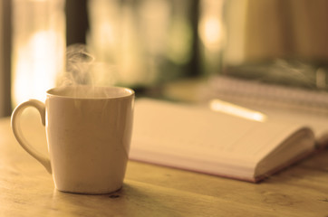 Coffee cup on the table with warm light