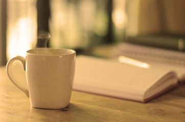 Coffee cup on the table with warm light
