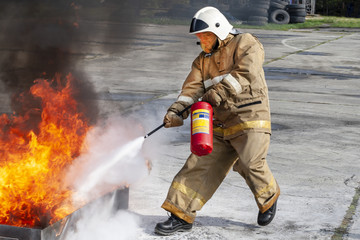 Firefighter during training with a huge fire in the brazier