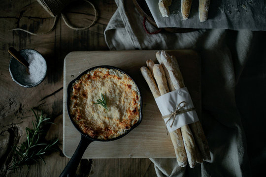 Melted cheese dip served with breadsticks
