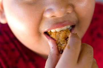 Obese children are happily eating fried chicken