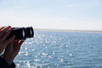 woman looking through binoculars