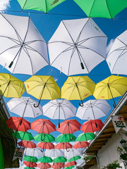 Fototapeta na wymiar Umbrellas suspended on the streets of Guatape Colombia