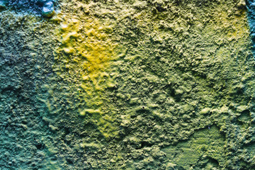 Abstract color painting on concrete block background (blue,green,yellow)