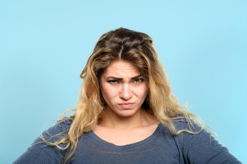 distrustful skeptic look. dissatisfied discontented displeased disgruntled woman portrait on blue...