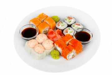 Set of sushi, rolls, uramaki, hosomaki, california, philadelphia, lava sauce, raw seafood, soy sauce, marinated ginger and wasabi, food on plate, white isolated background Side view For the menu