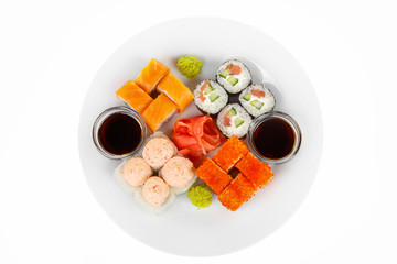 Set of sushi, rolls, uramaki, hosomaki, california, philadelphia, lava sauce, raw seafood, soy sauce, marinated ginger and wasabi on plate, white isolated background view from above For the menu