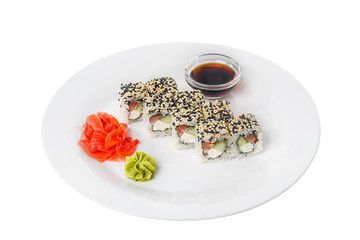 Sushi, rolls, uramaki with sesame, avocado, cucumber, cheese and salmon, fish, raw seafood, soy sauce, marinated ginger and wasabi, food on plate, white isolated background Side view For the menu
