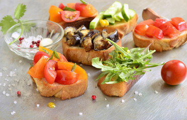 Various crostini with vegetables and herbs