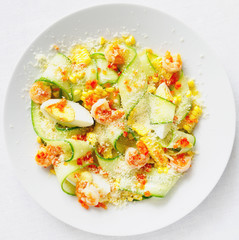 bright summer salad of corn, cucumber, egg, fried in garlic oil and chili prawns sprinkled with lemon juice
