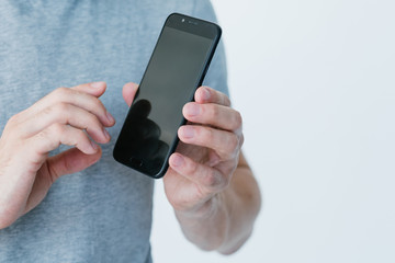 mobile business and e-commerce. online digital marketing. make money on the internet. man holding smart phone with empty black screen.