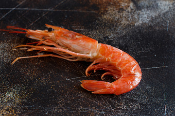 Raw shrimp on a dark table