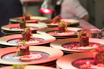 A chef prepares a fried beef gourmet dinner.