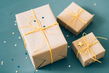 holiday presents delivery. selection of gift boxes packed in craft paper and tied with yellow twine. celebration gratitude and congratulation concept.