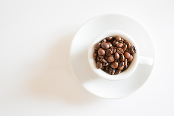 coffee cup full of roasted coffee beans