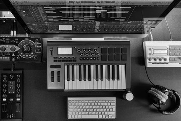 Home music studio - dj and producer equipment on the black table in monochrome color