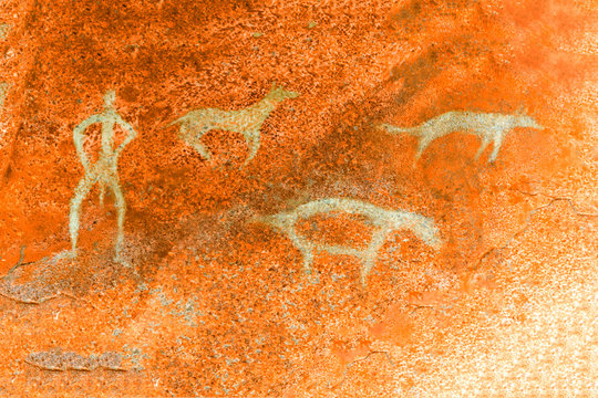 An image of ancient people and animals on the wall of the cave. ancient history. era, era, archeology