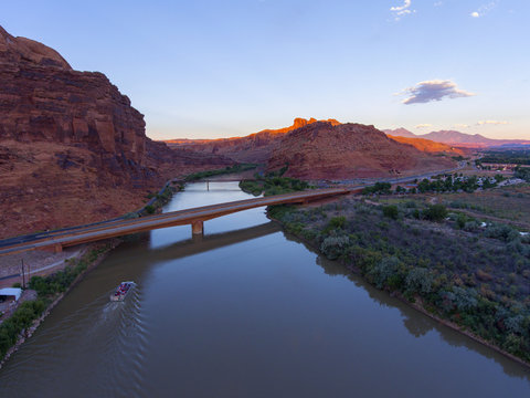 Aerial view of Colorado River and La Sal Mountains near Arches National Park at sunset in Moab, Utah, USA.