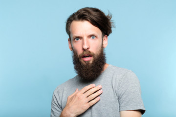 utter indignation. young bearded man shocked from someones impertinence or impudence. people...
