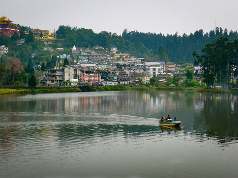 A boat crosses the deep green waters of  Mirik Lake, a popular hill station resort  near Darjeeling in the Himalayan foothills