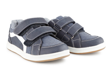 children's sports sneakers of gray color, boyish casual shoes isolated on white