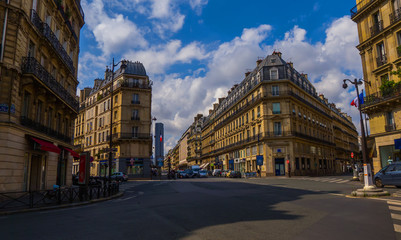 Fototapeta na wymiar Crossroad of streets of Paris without tourists with a beautiful architecture and cloudy sky (Saint-Germain, 6th district)