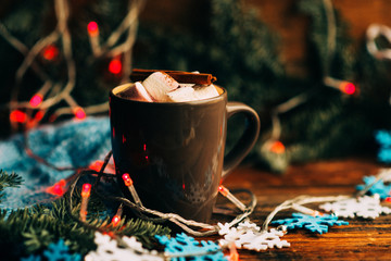 Glass cup of cocoa with marshmallows on wooden table