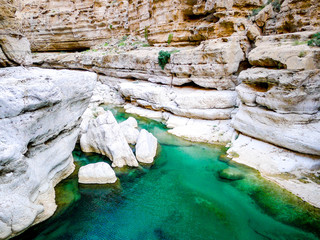 Bright, turquoise blue waters of Wadi Shab, a canyon near Muscat in Oman