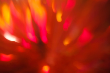 abstract lens flare background. red defocused bokeh lights. blurred christmas wallpaper decor. festive glowing design.