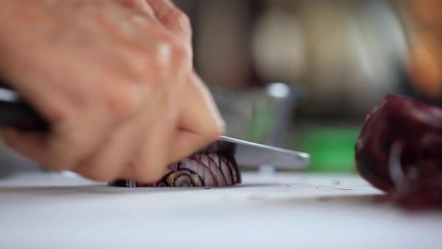 chef masterfully cutting colorful vegetables on a cutting board

