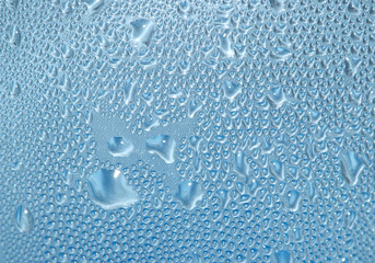 Condensed  water drops on blue plastic bottle